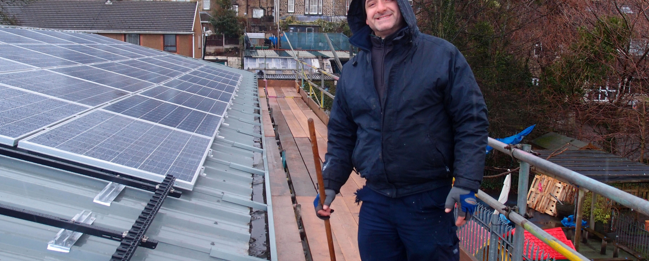 Ian Mecklenburgh of Alian Energy installing a rooftop solar thermal system