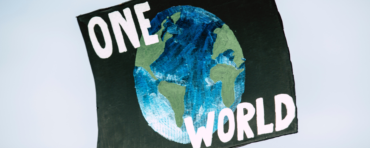 A sign saying 'One World'