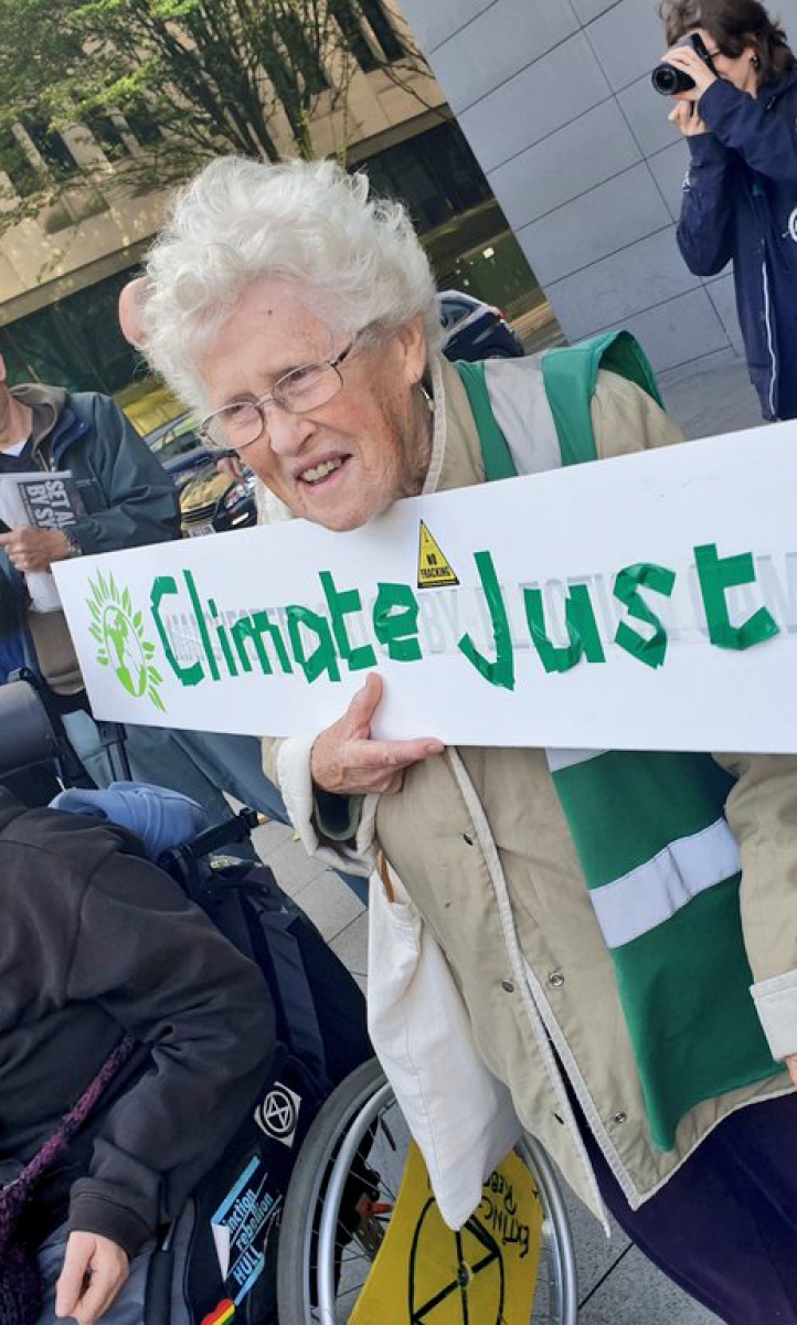 Extinction Rebellion protester with placard reading 'Climate Justice'