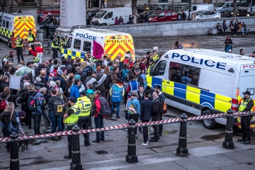 Police officers controlling a group of Extinction Rebellion protestors