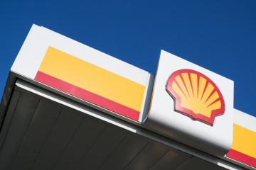 A shell petrol station sign, viewed from an upwards angle